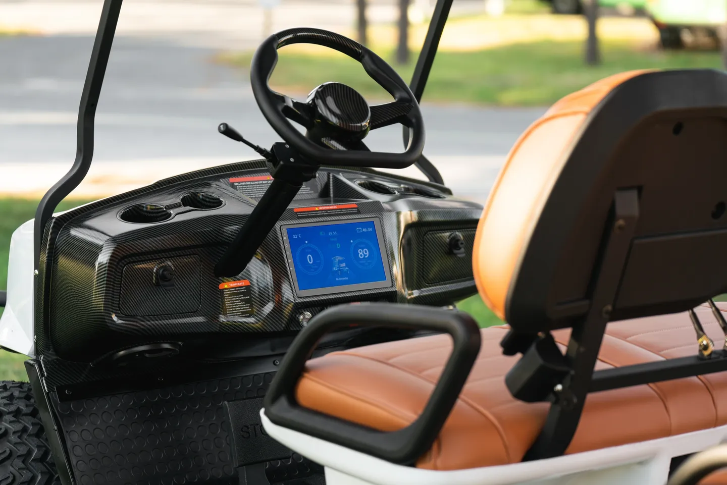 A golf cart with the steering wheel and dashboard in view.