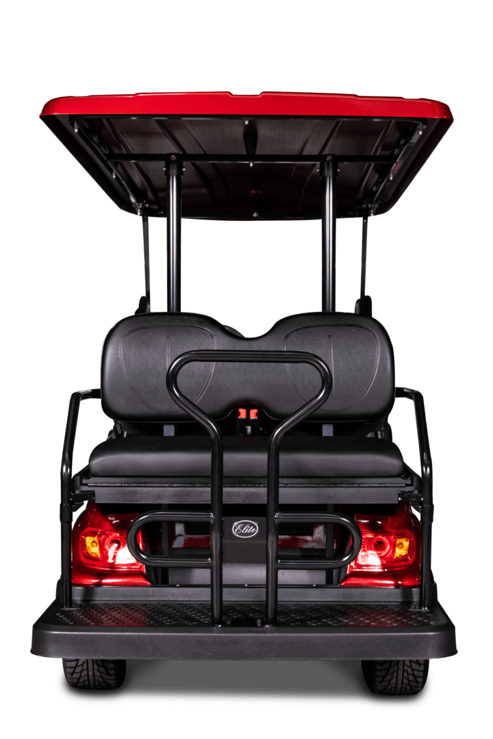 A golf cart with two seats and the back lit.